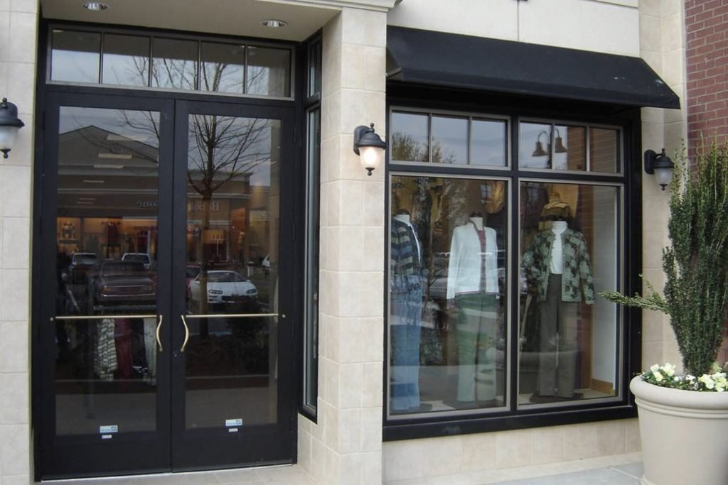 Large corner glass storefront system with doors and display windows
