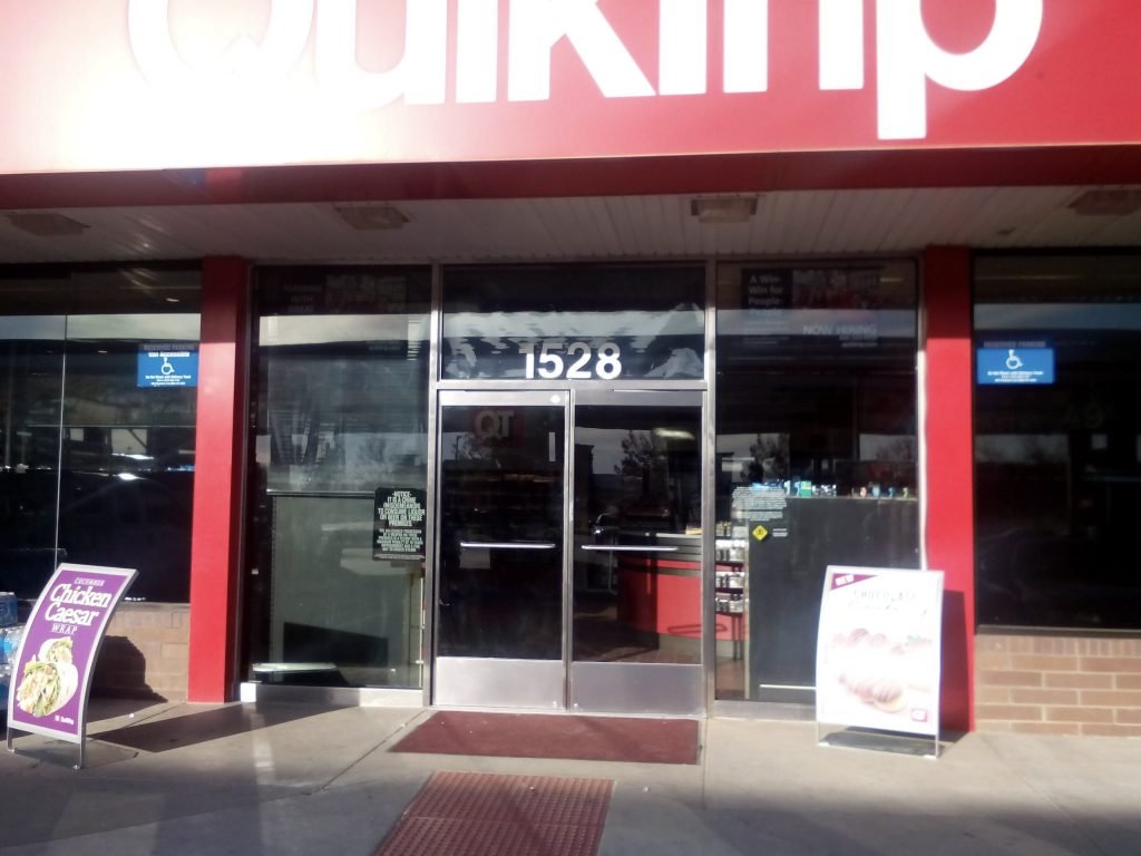 Automated glass storefront doors at retail shop