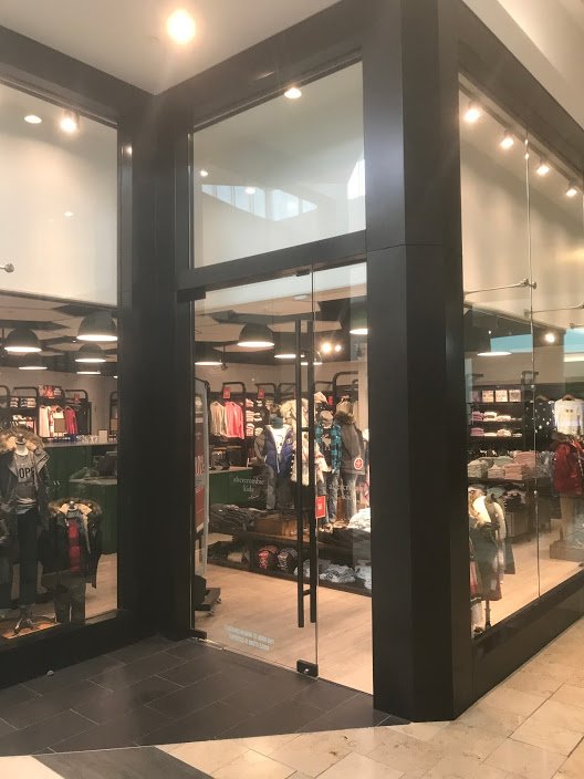 Glass storefront doors with masonry frame